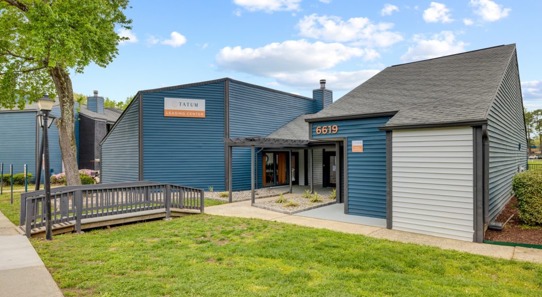 the exterior of a building with blue siding and a green grassy area at The  Tatum